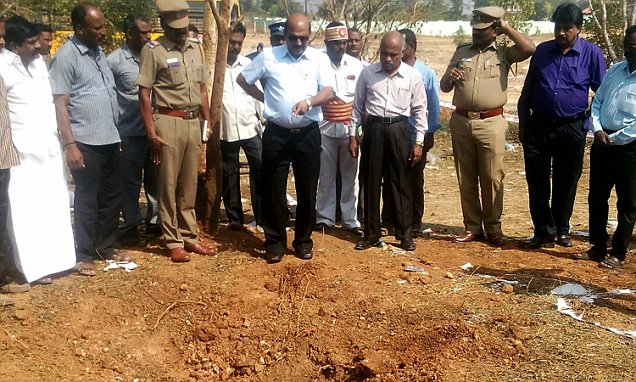 Indian authorities inspect the site of a